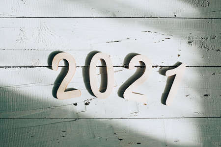 2021 figures New Year in the sun on a white wooden backgroundの写真素材