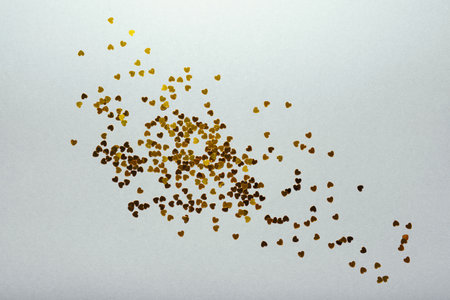 Hearts sequins on a white background, flat lay top view