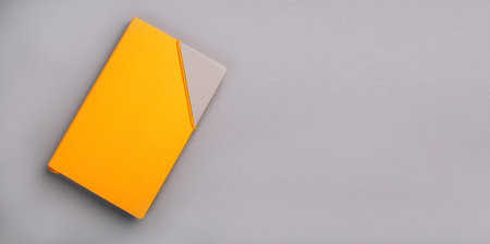 Yellow diary on a gray background, flat layの写真素材