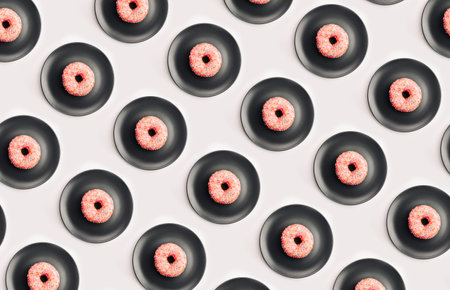 Pink donut on a gray plate, flat lay patternの写真素材