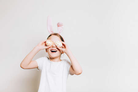 Child in rabbit costume and time for fun. adorable girl wearing funny hare ears. Easter spring...