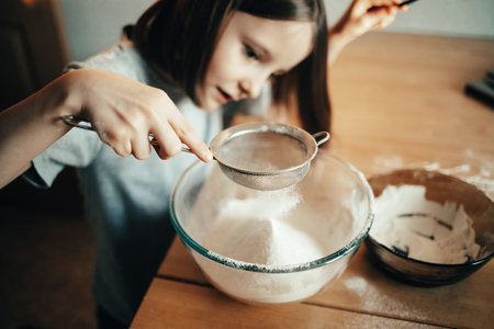 A girl cooks a pie in the kitchen, isolation exercise for a childの写真素材