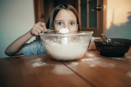 A girl cooks a pie in the kitchen, isolation exercise for a childの写真素材