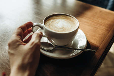 Cup of latte on the table top view. Breakfast at the cafeの写真素材