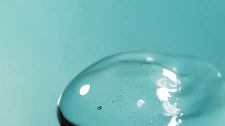 Cream gel drops transparent cosmetic sample texture with bubbles on blue background