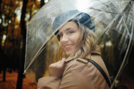 Young smiling happy woman in autumn forest