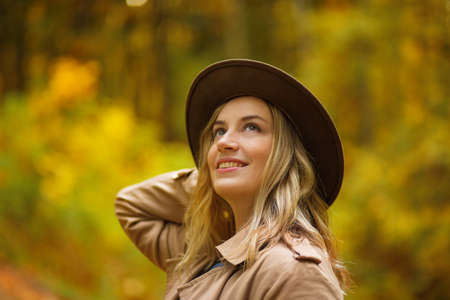 Young smiling happy woman in autumn forest