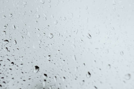 Raindrops on window glass in defocus, depression and sadness conceptの写真素材