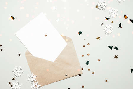 Blank letter in an envelope for the new year. Holiday concept, confetti and giftsの写真素材
