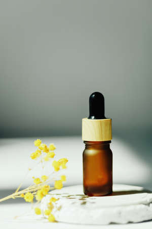 Amber bottle with serum or essential oil. Natural organic cosmetic, aromatherapy message oil.の写真素材
