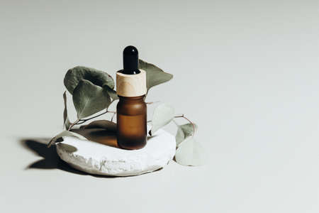 Amber bottle with serum or essential oil. Natural organic cosmetic, aromatherapy message oil.の写真素材
