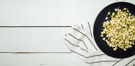 Macrobiotic food from beans sprouts for vegetarian meal on the plate. Healthy diet and vegetarian food. Raw beansの写真素材