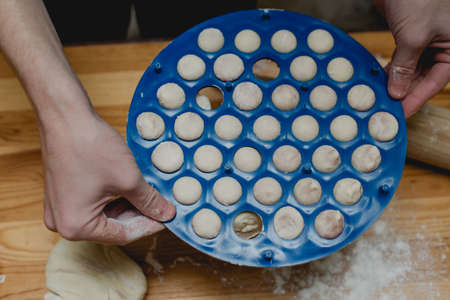 cooking homemade dumplings on a wooden tableの写真素材