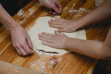 the cook rolls the dough, person kneading doughの写真素材