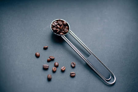 metal silver measuring spoon with coffee beansの写真素材