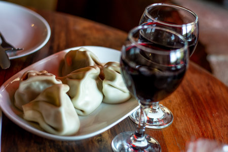 two glasses of red wine against which Khinkali lieの写真素材