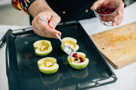dessert with apple, cinnamon, nuts, cranberries and ice creamの写真素材