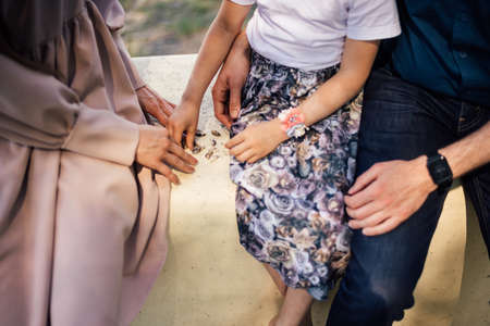 Mother with daughters with seashells enjoying summerの写真素材