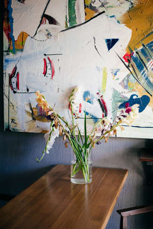 a bouquet of multicolored gladioli on the tableの写真素材