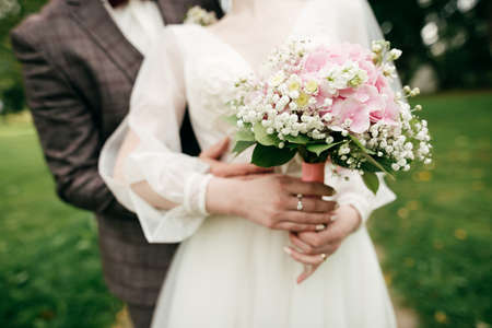 Bride holding her bouquet with pink hydrangeaの写真素材