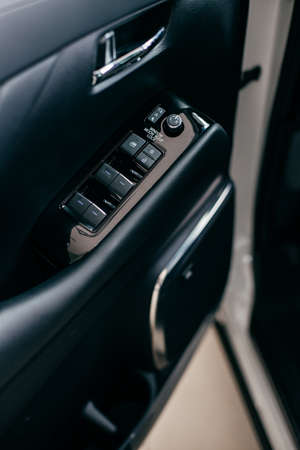 Car interior detail. Closeup of controls on the doorの写真素材