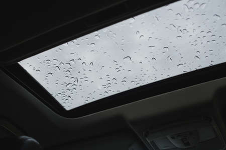 Rainy days, Rain drops on car window, rainy weather, rain backgroundの写真素材