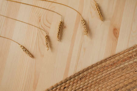 ears of wheat on a wooden background, space for textの写真素材