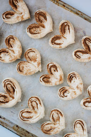 buns in the form of hearts on a baking sheet homemadeの写真素材
