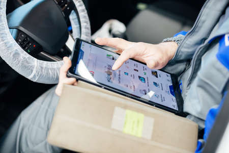 Male engineer makes computer diagnostics of the car in auto service.