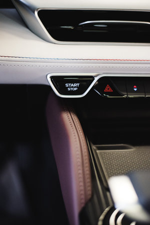 Car start stop system with finger pressing the button. High quality photo