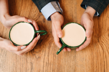 two cups of coffee in the hands of the newlywedsの写真素材