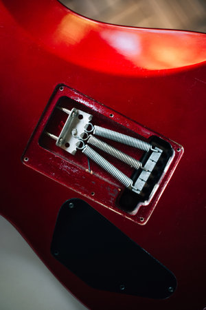 Red electric guitar body on guitar repair desk or in a repair work shop.の写真素材