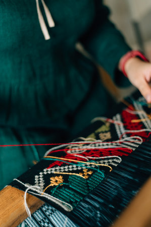 the craftswoman weaves the pattern tightly. High quality photoの写真素材