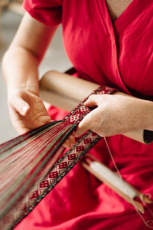 a craftswoman weaves a beltの写真素材