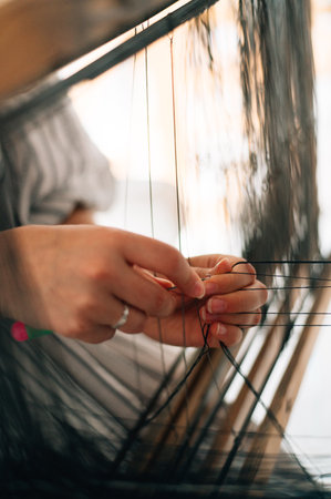 the craftswoman weaves the pattern tightlyの写真素材