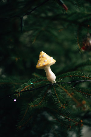 Christmas tree toy in the form of a fly agaric on a live tree. High quality photoの写真素材
