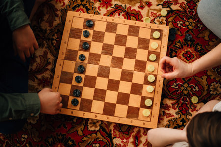 children playing checkers on the floor. High quality photoの写真素材