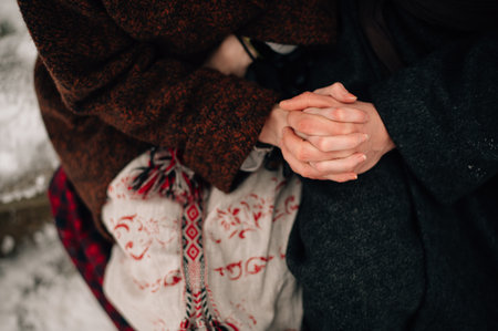 hands of newlyweds in national costumes. High quality photo