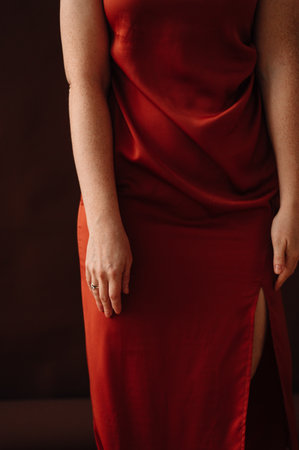 red haired girl in orange satin dress. High quality photoの写真素材