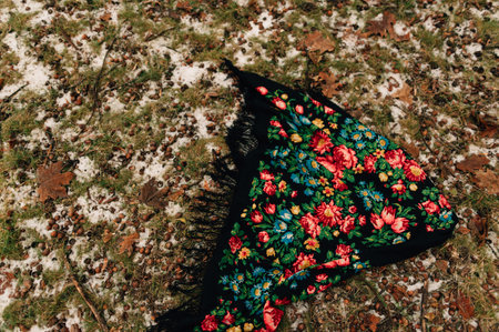 a scarf with roses lies on the snow. High quality photo