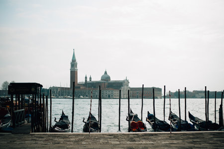 Gondolas moored in Venice with the cathedral in the background. High quality photoの写真素材