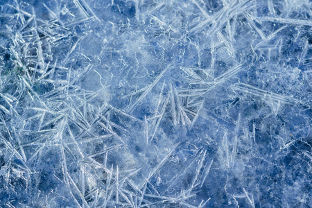 Winter snowy banner, frozen background. A scattering of large long ice crystals in the form of needles on the river in winter. Dark and Light. High quality photoの写真素材