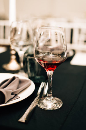 Glass of red wine on a black tablecloth. High quality photoの写真素材