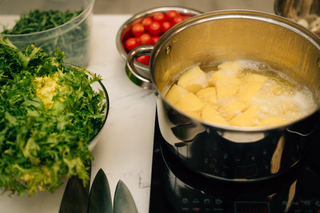 Potatoes are boiled in a saucepan. High quality photoの写真素材