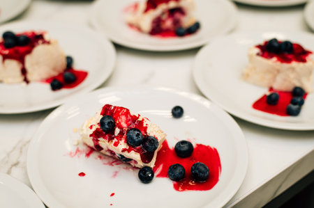 Pieces of meringue roll with jam, strawberry, blueberryの写真素材