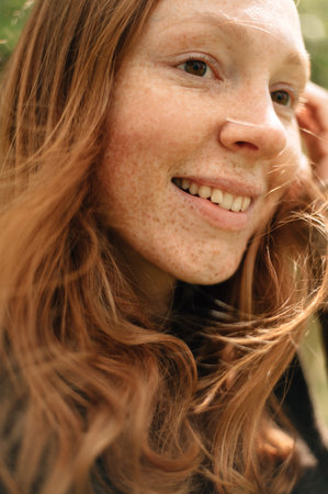 Portrait of a red-haired smiling girl. High quality photoの写真素材