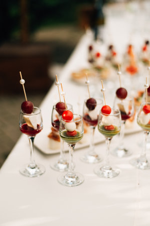 Skewers with appetizers on the banquet tableの写真素材