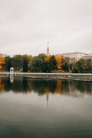 A view of a building with a spire across the river in Minskの写真素材