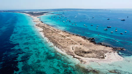 Aerial view of the beaches of Ses Illetes on the island of Formentera in the Balearic Islands, Spain - Turquoise waters on both sides of a sand strip in the Mediterranean Seaの写真素材