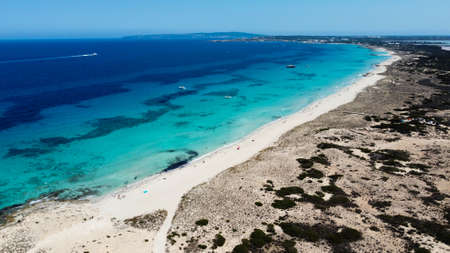 Aerial view of the beaches of Ses Illetes on the island of Formentera in the Balearic Islands, Spain - Turquoise waters on both sides of a sand strip in the Mediterranean Seaの写真素材